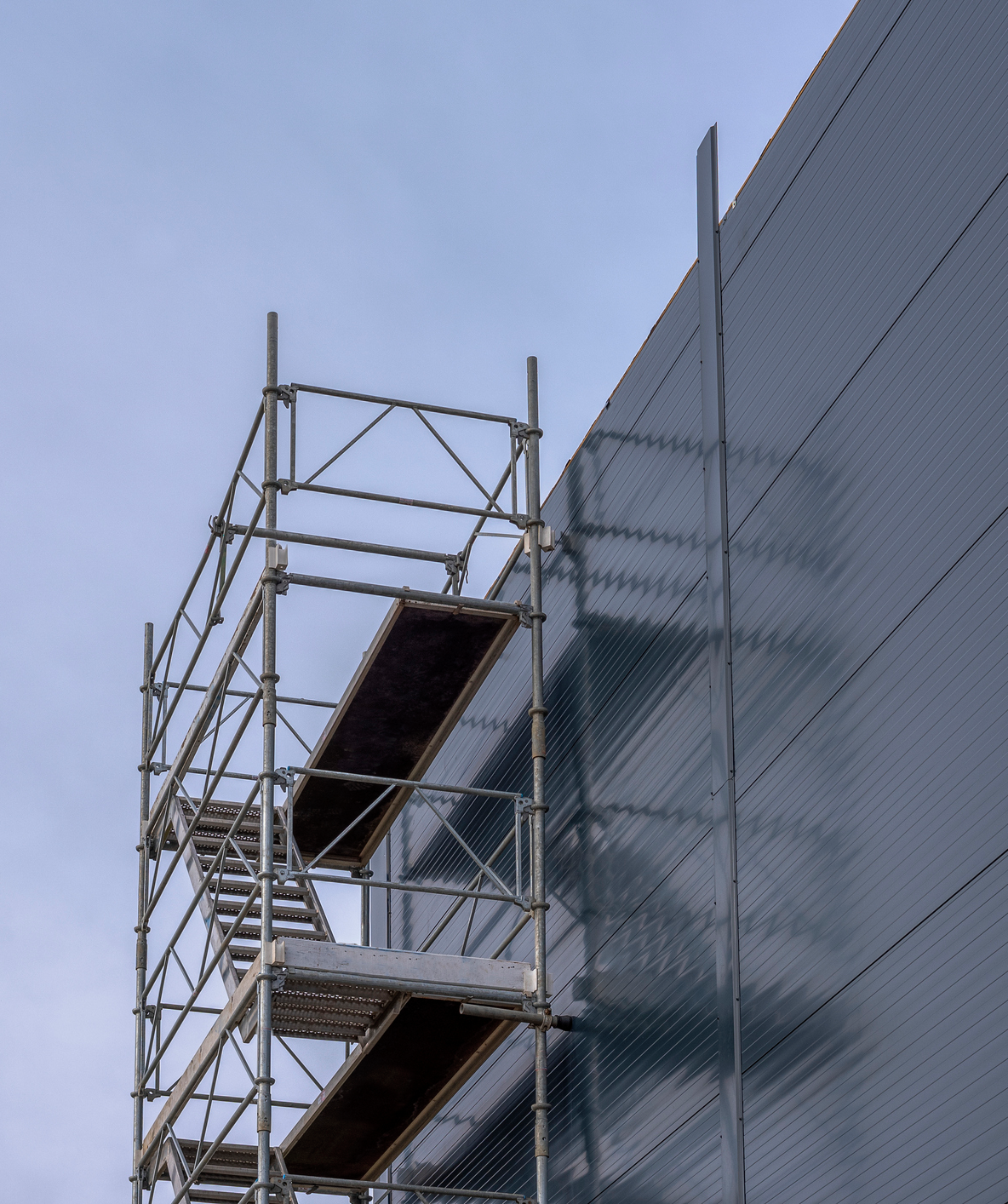 Construction scaffolding against blue sky